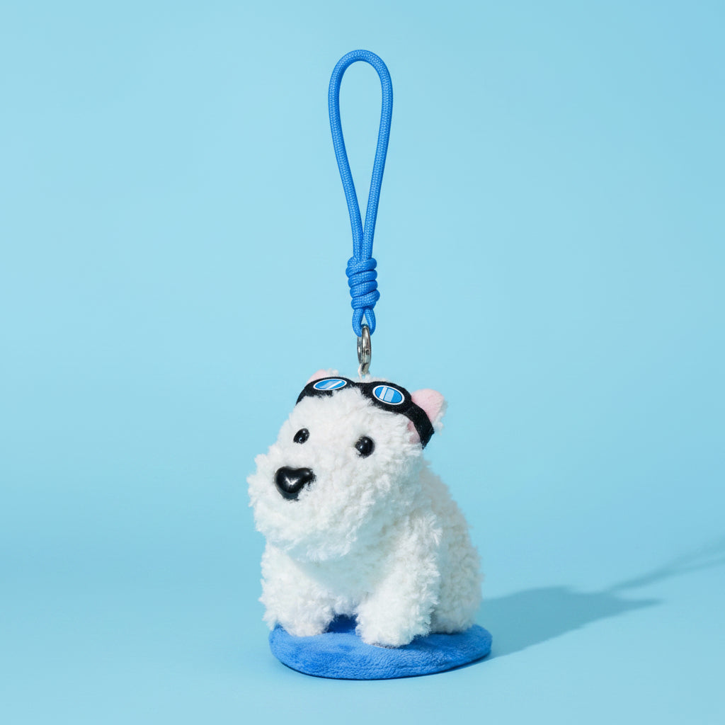 Two plush keychains on a split background, one white dog with sunglasses and blue strap, the other pink and white character with yellow legs and red strap.